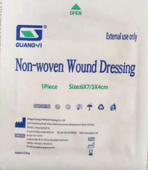 Adhesive non-woven wound dressing